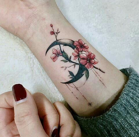 Crescent moon and flower watercolor tattoo design for wrist looking cool.