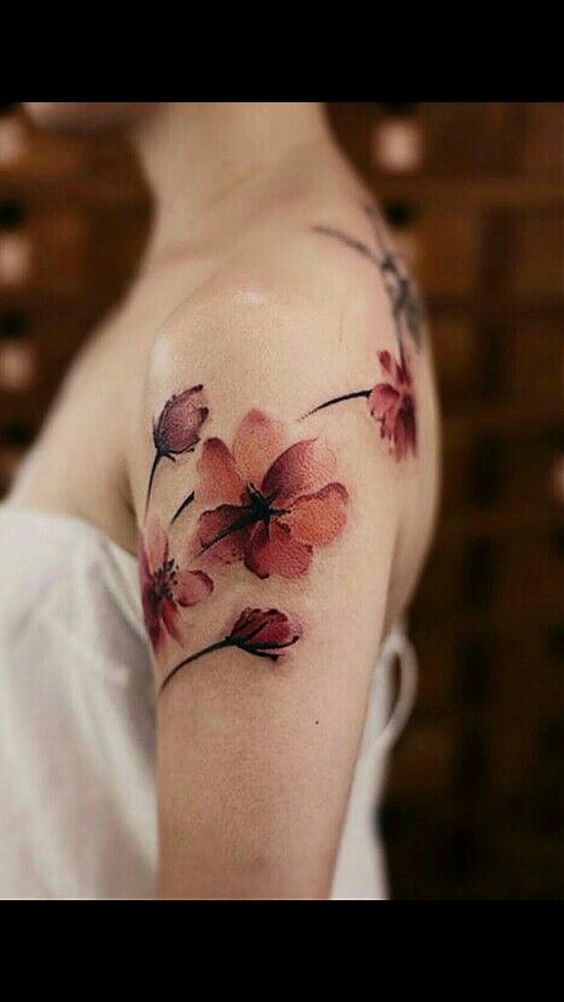 Floral watercolor shoulder tattoo idea.