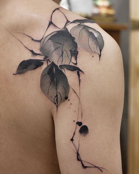 Gorgeous black and grey leaves tattoo on shoulder.