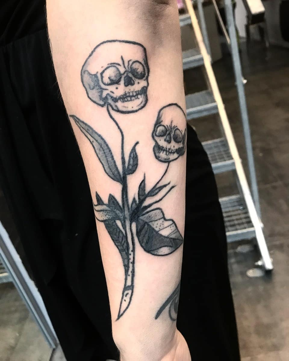 Gorgeous black and grey line work skull plant.