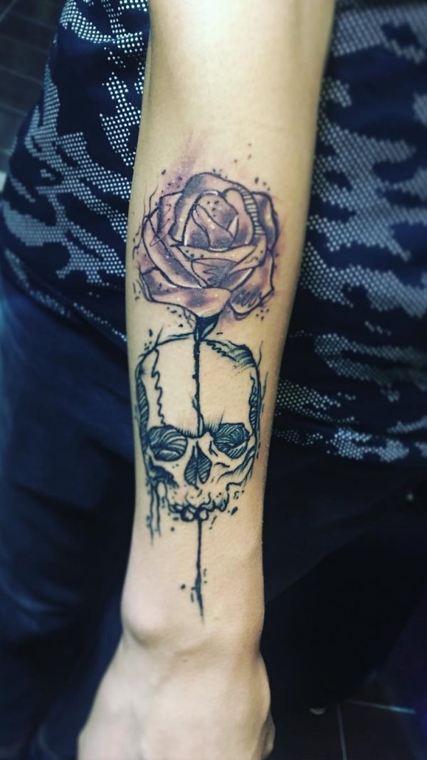 Line work skull tattoo with rose on half sleeve.