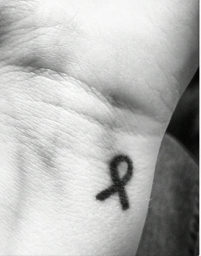 Little Cancer ribbon wrist tattoo.