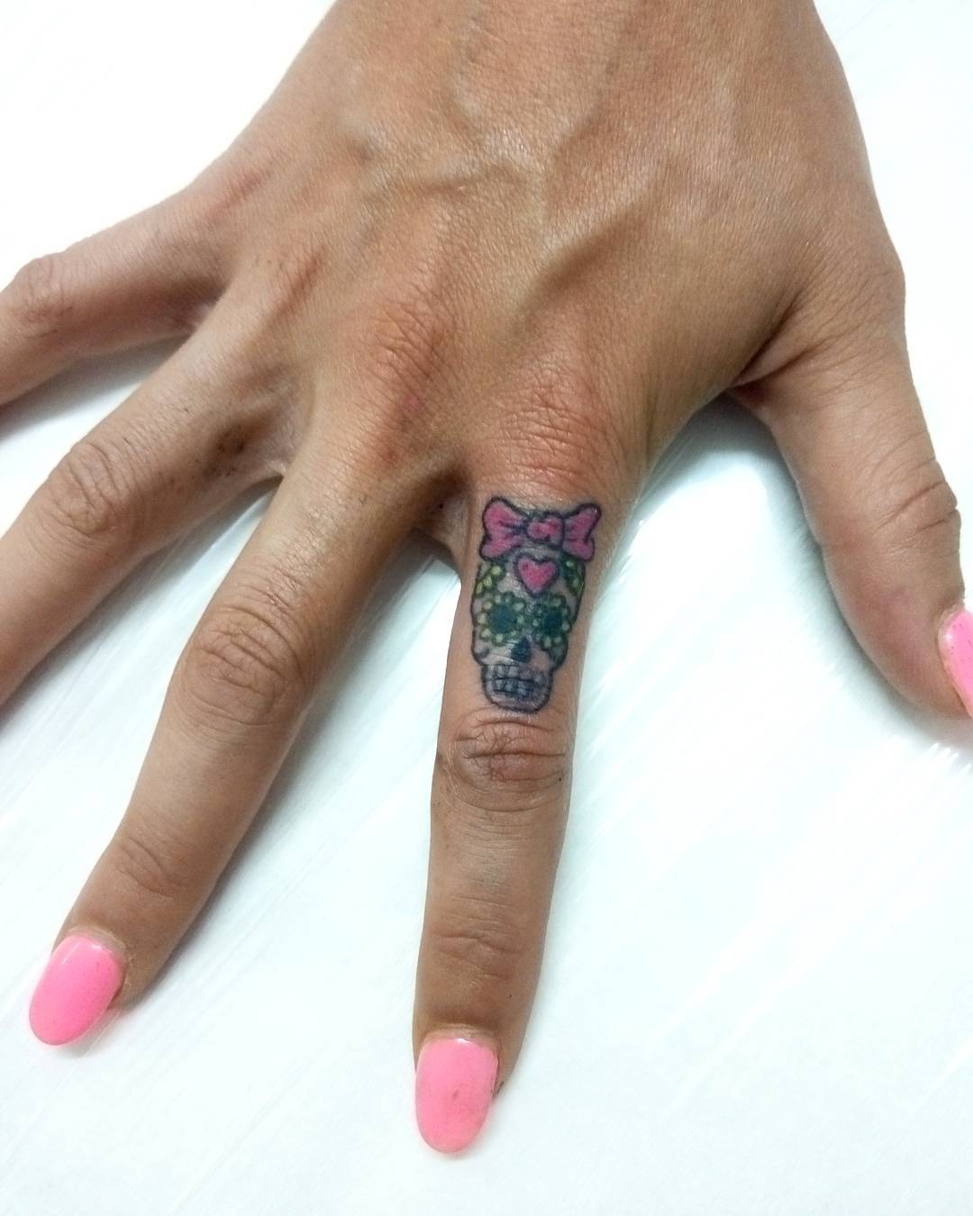 Miniman candy skull finger tattoo idea.