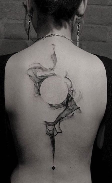Rocking black and grey smoke tattoo looking perfect on back.