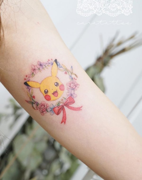 Sime fine line Pikachu tattoo with flower and ribbon.