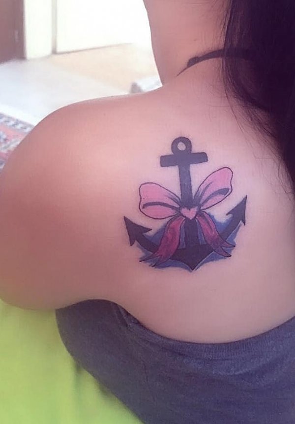 Sweet ribbon tattoo with anchor on back shoulder.