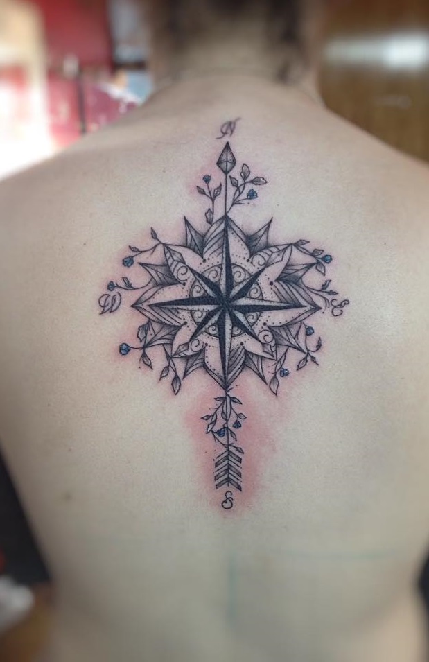 Upper back is the perfect body area to showcase this mandala compass tattoo.