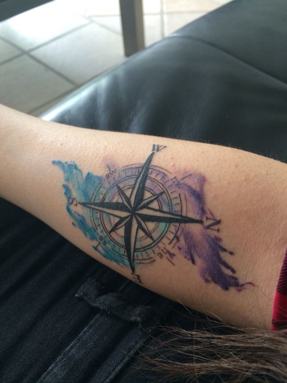 Water color tattooing technique adds color and creativity to compass tattoo.