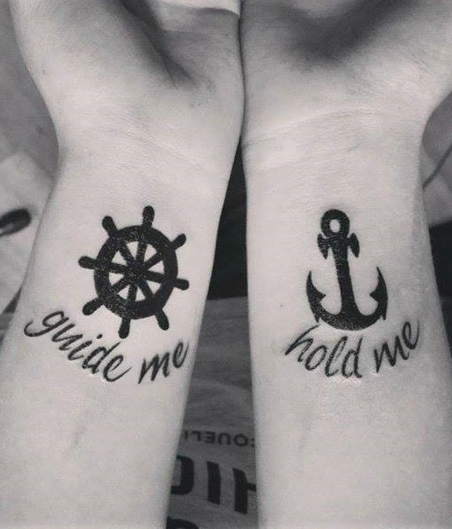Beautiful couple tattoo of wheel and anchor to show your love for sea.