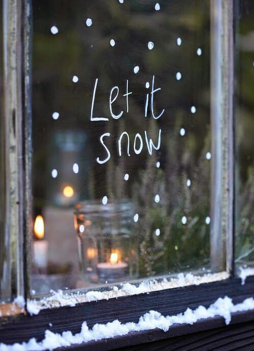Classic candle decoration in a snowy window.