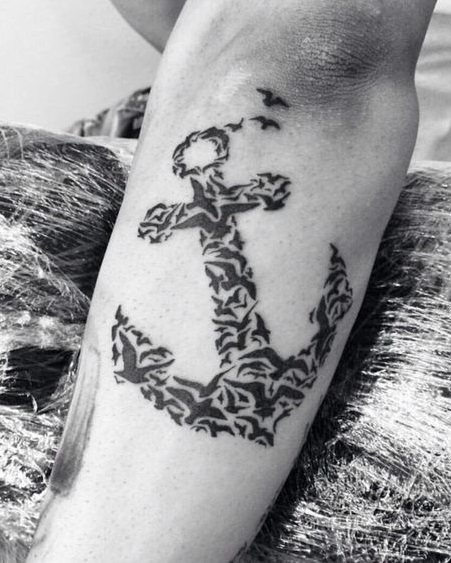 Exclusive anchor tattoo made out of small and large birds.