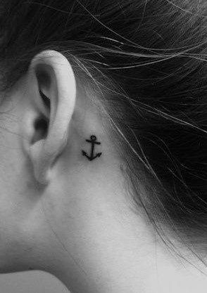 Eye-catching behind the ear anchor tattoo.