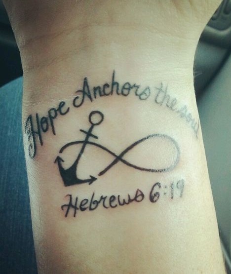 Hope Anchors The Soul quote on wrist with infinity anchor tattoo.