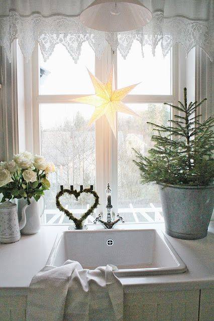 Kitchen window is decorated with big star.