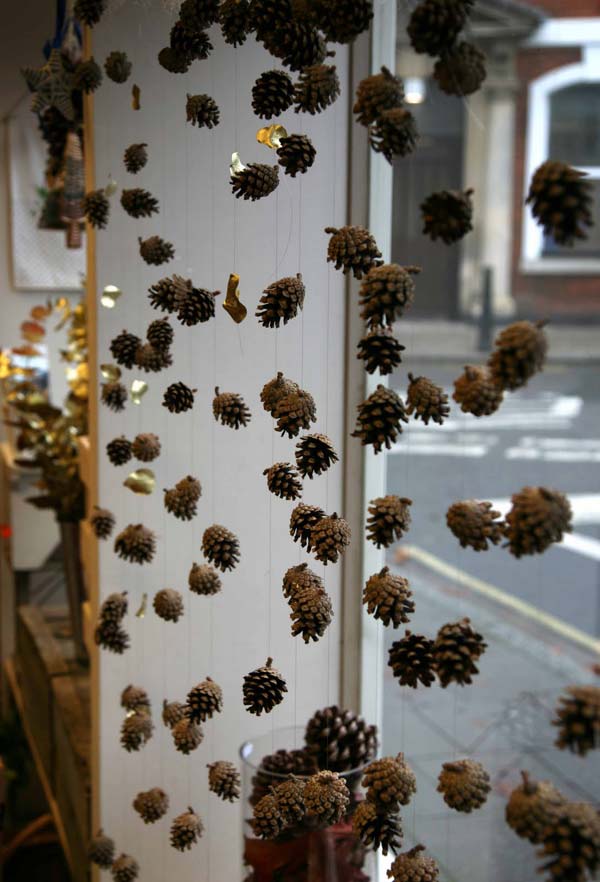 Pinecones attach into string and hanging on window.