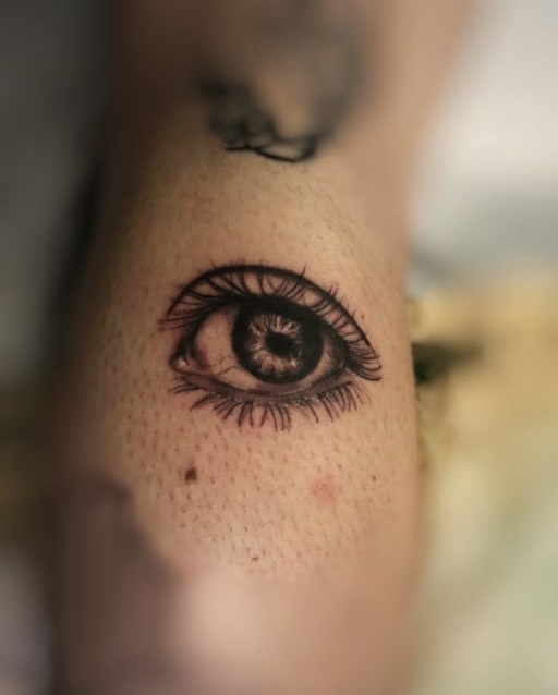 Simple and detailed eyeball tattoo on half sleeve.