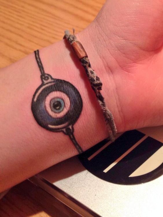 Swanky Greek evil eye tattoo as bracelet.