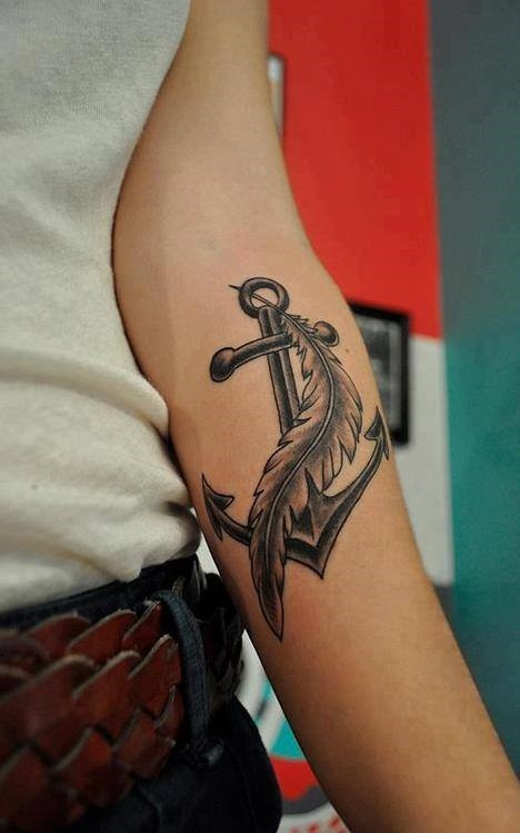 The combination of feather and anchor tattoo is ironic since feather tattoos mean freedom and anchor tattoos means stability.