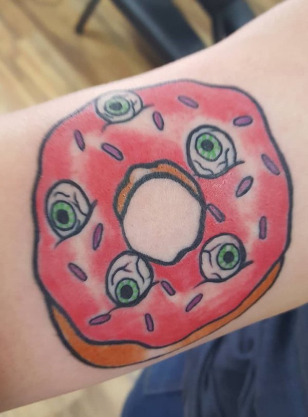 Weird eyeball tattoo in shape of donut.