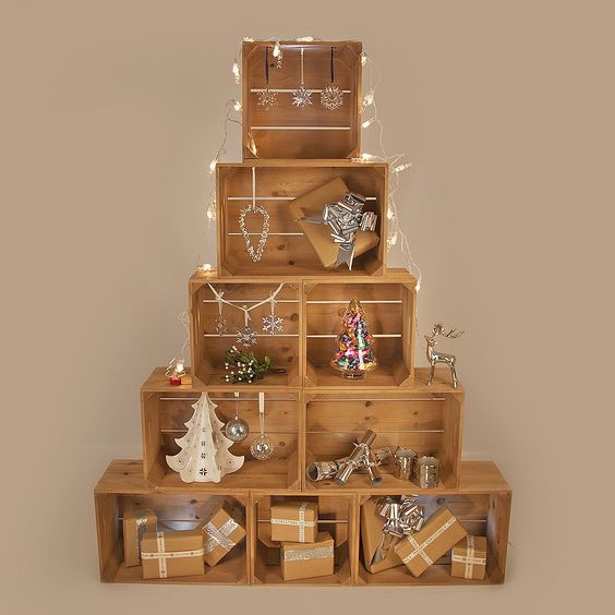 Wooden crate arranged as tree and decorated with beautiful ornaments.