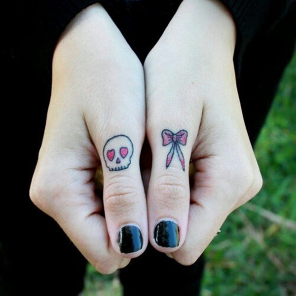A skull with pink heart-shaped eyes and pink bow finger tattoo set