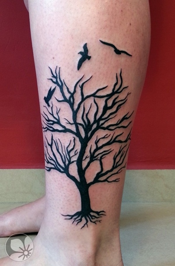 Appealing black dead tree tattoo.