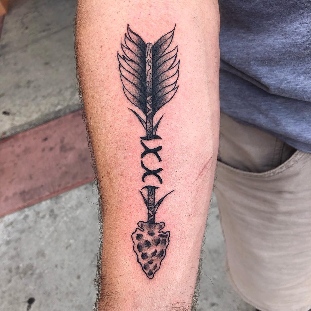 Arrow Tattoo With Two Xs In The Middle.
