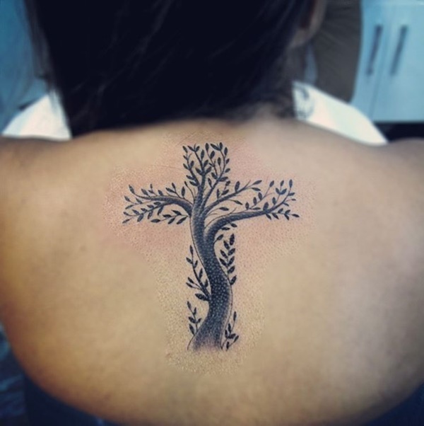 Artistic tree tattoo resembles with cross.