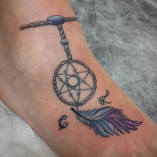 Attractive dreamcatcher tattoo with alphabets on feet.