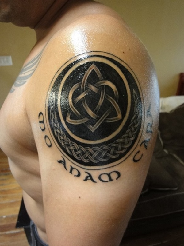 Awesome black meaningful celtic tattoo on upper arm.