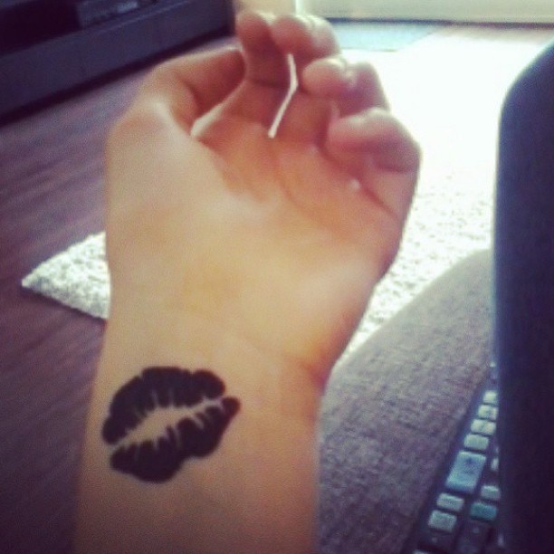 Black Lips Kiss Wrist Tattoo.