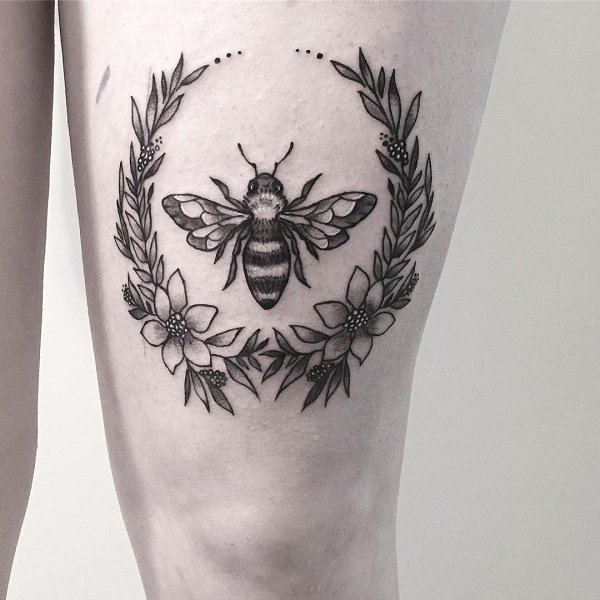 Black and grey inked bee tattoo.