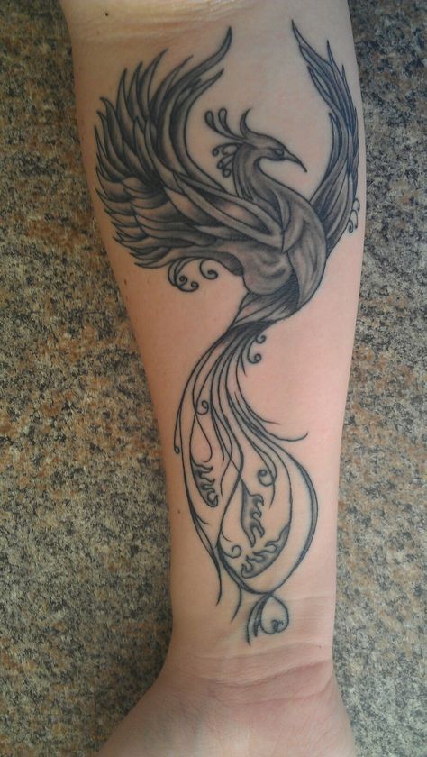 Black & grey phoenix tattoo on forearm.