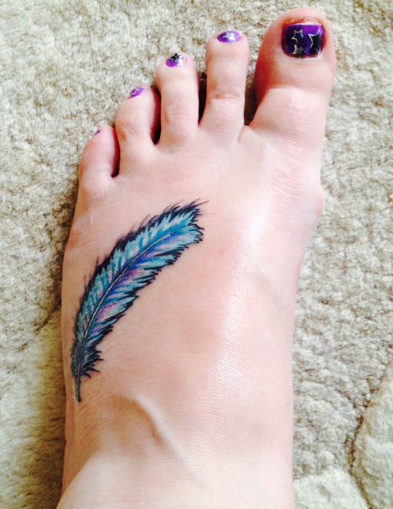 Blue feather tattoo on foot.