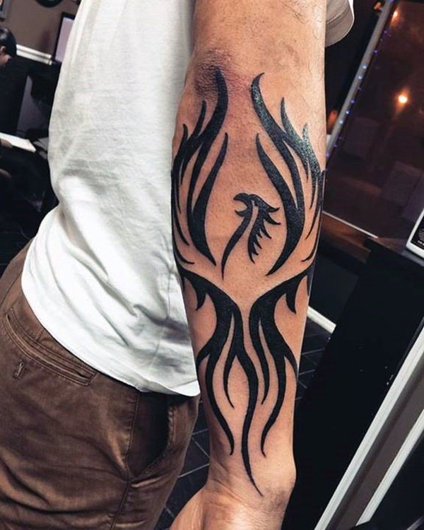 Bold tribal tattoo on arm.