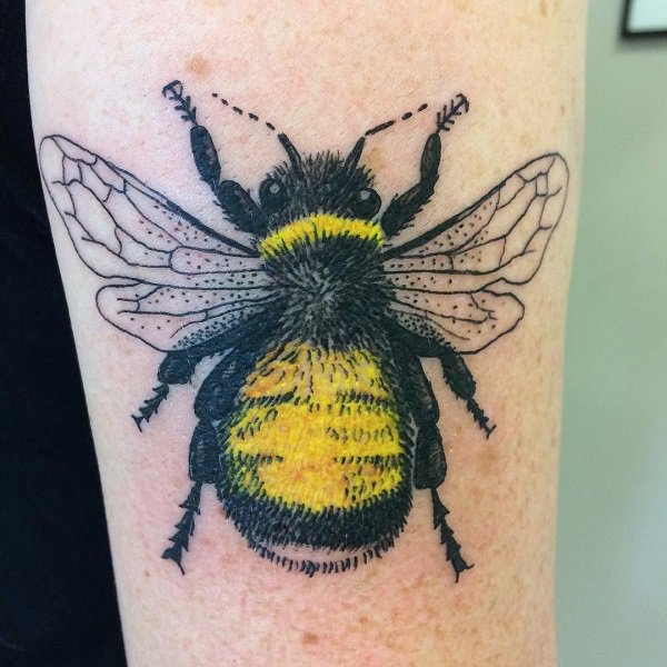 Bright yellow bee tattoo.
