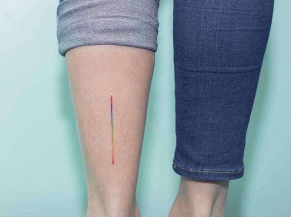 Colorful Single Line Tattoo On Lower Leg.