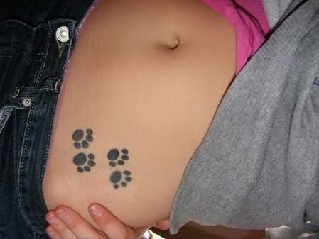 Cute dog paw tattoo on waist.