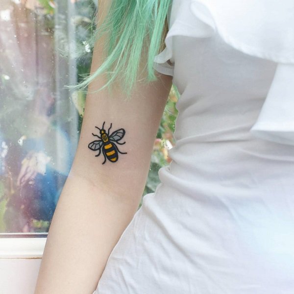 Cute upper arm bee tattoo.