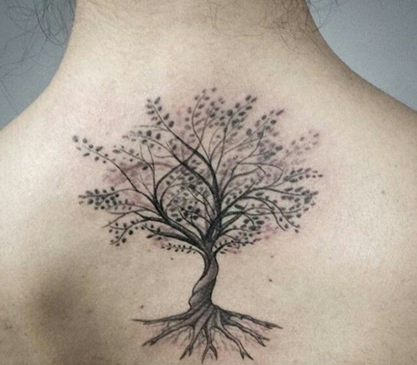 Elegant tree tattoo on upper back.
