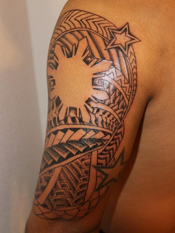 Filipino tribal sun tattoo design on full sleeve of a man. - Blurmark