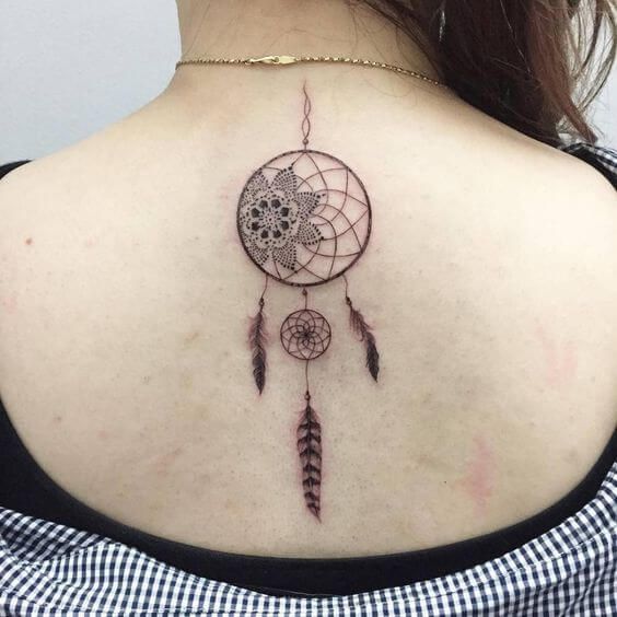 Geometric dreamcatcher tattoo on upper back.