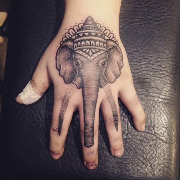 Giant elephant tattoo for your hand Just look at the long teeth design.