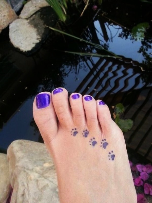 Little dog paw print tattoos on foot.