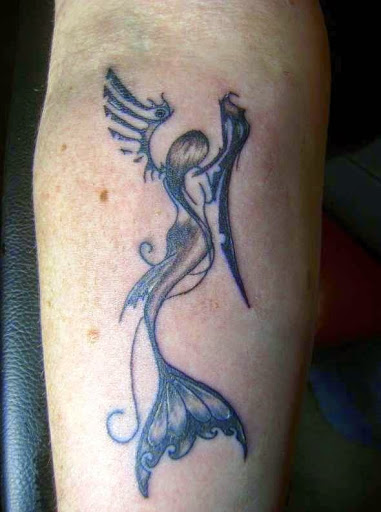 Look at this beautiful small mermaid tattoo with wings.