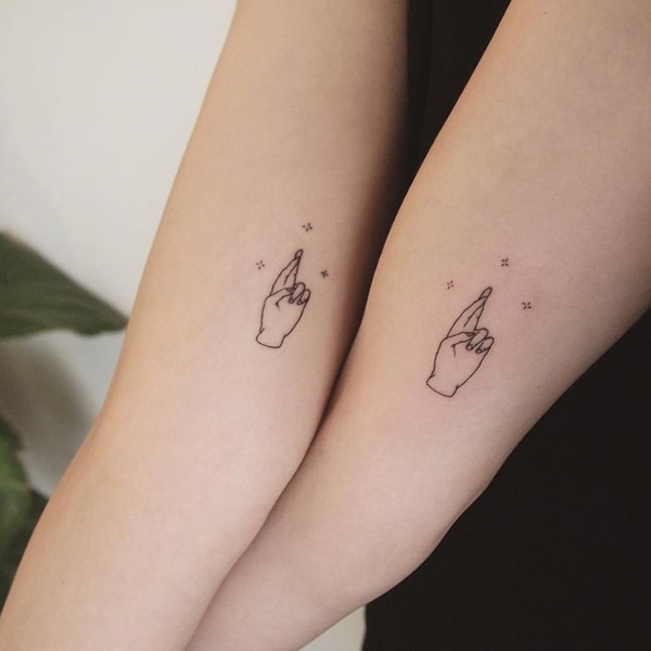 Lovely Finger Cross Tattoo On Both Hands.