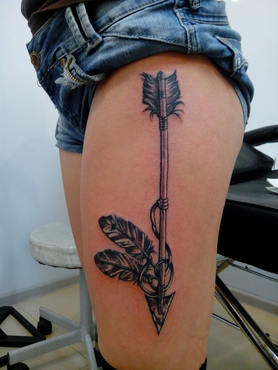 Marvelous Arrow Tattoo With Feather On Thigh.