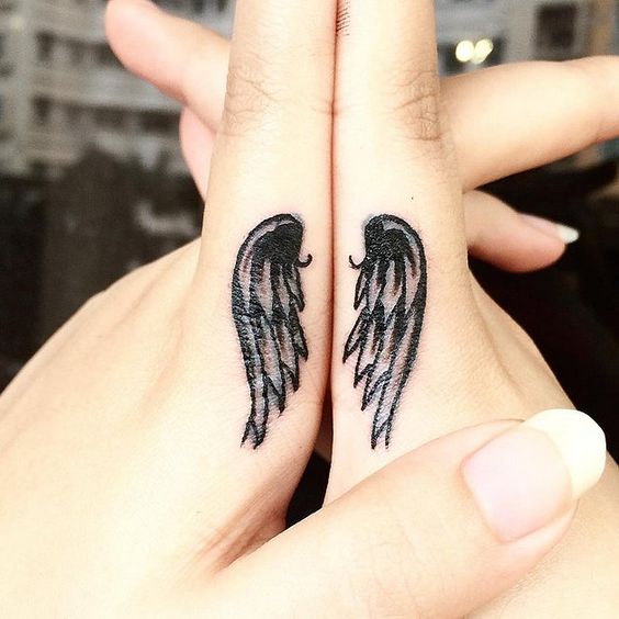 Marvellous Wing Tattoo On Fingers.