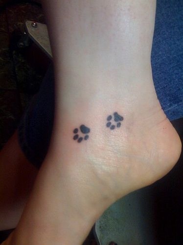 Minimize dog paw ankle tattoo.