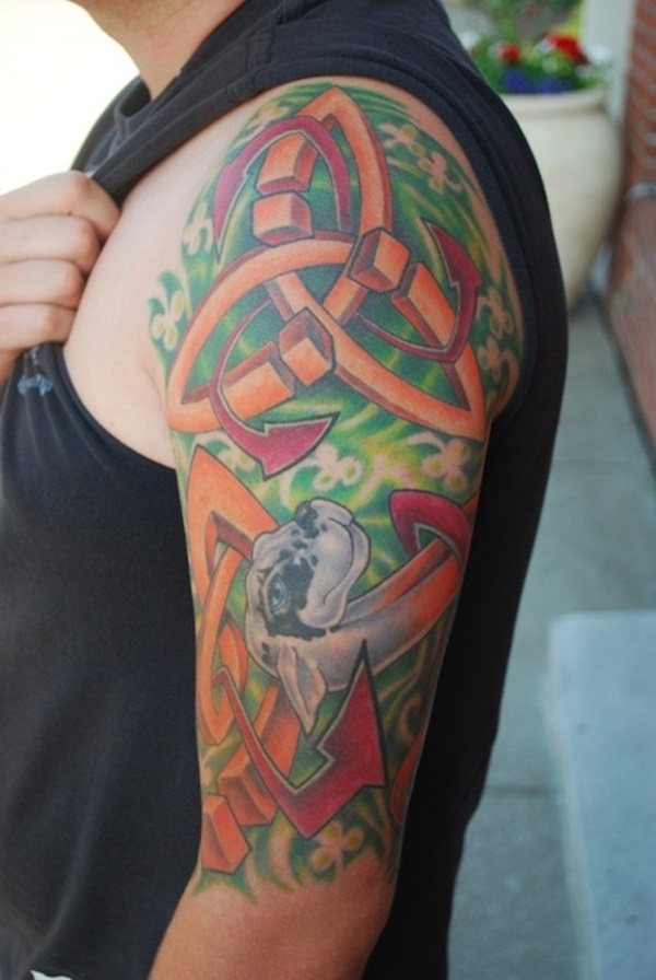 Multicolor celtic tattoo on shoulder with dog.